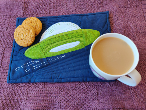 Open Liberty logo rug mug with tea and biscuits